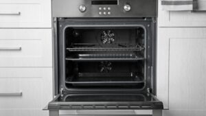 An open oven is preheating with empty racks, ready for baking chicken karaage