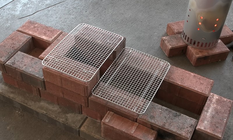 A brick oven with a grill positioned on top, showcasing a rustic cooking setup