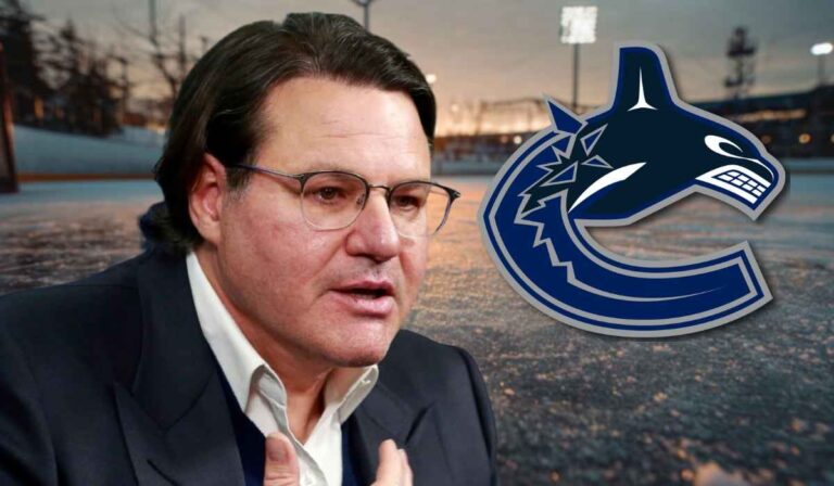 Hockey executive beside the Vancouver Canucks logo