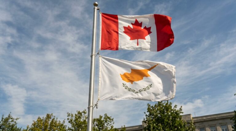 The Canadian flag flies above the white flag of Cyprus on a tall flagpole